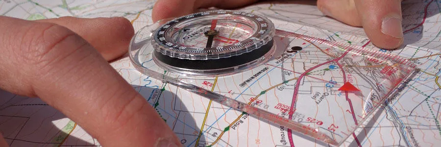 Using a compass and a paper map to navigate